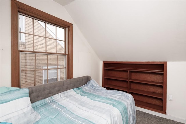 bedroom with vaulted ceiling and carpet flooring