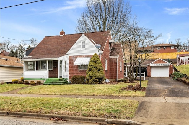 view of front facade with an outbuilding, a garage, and a front lawn