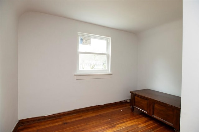 empty room with dark hardwood / wood-style flooring