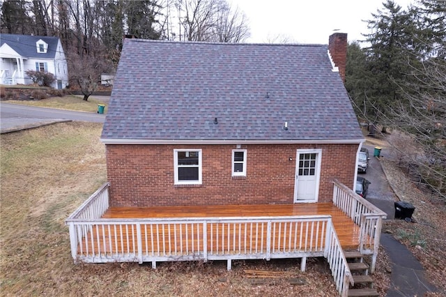 rear view of property featuring a deck