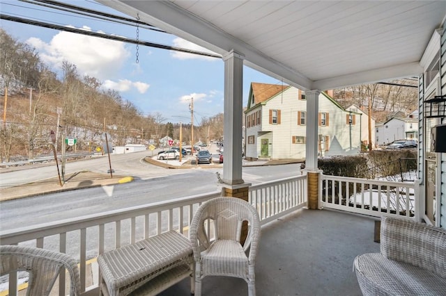 balcony with covered porch and a residential view