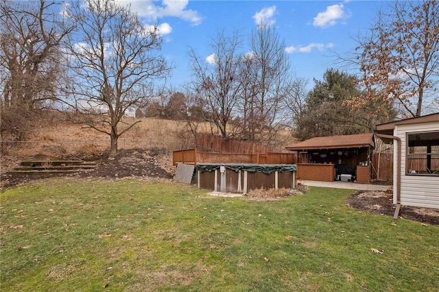 view of yard featuring a covered pool