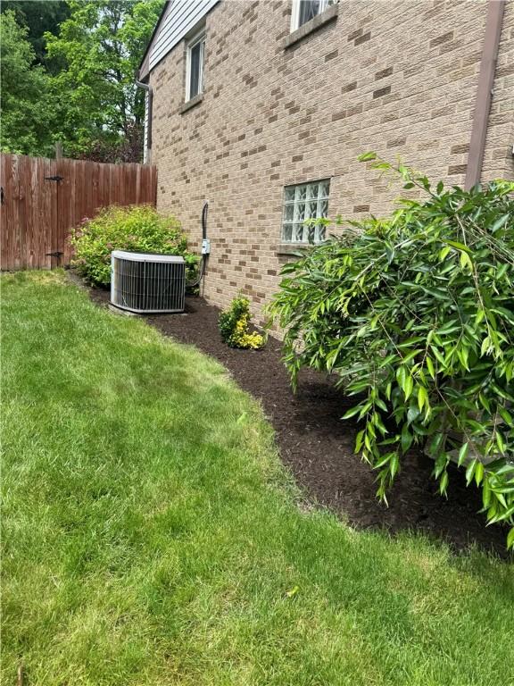 view of yard with fence and cooling unit