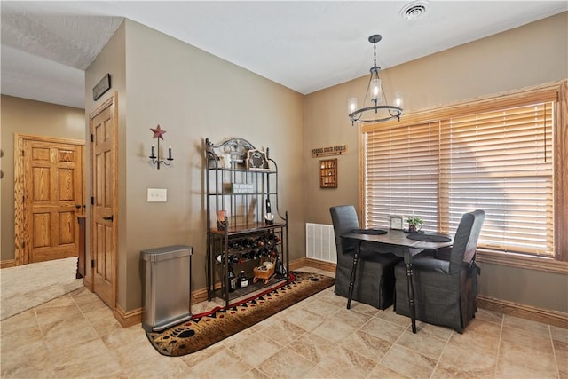 dining space with an inviting chandelier