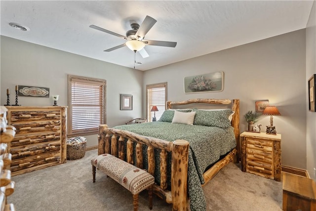 bedroom featuring ceiling fan, carpet, and multiple windows