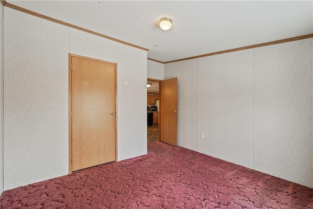 spare room featuring carpet flooring and crown molding