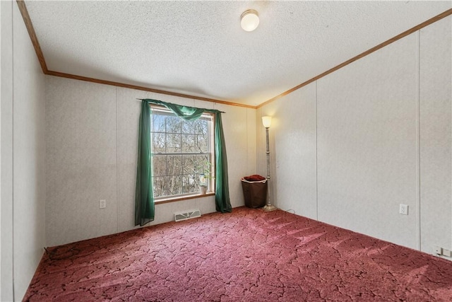 spare room with a textured ceiling, crown molding, and carpet floors