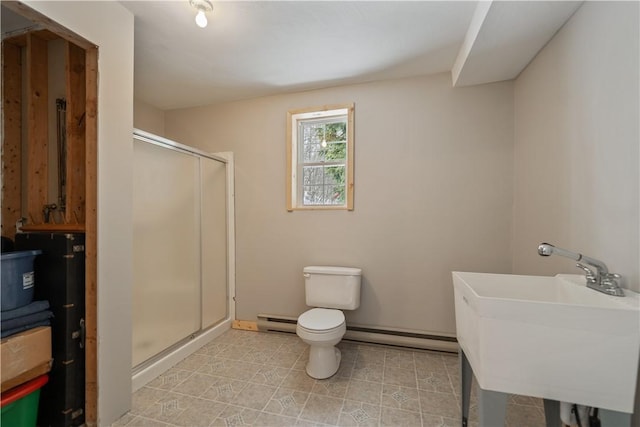 bathroom with toilet, a baseboard radiator, a shower with shower door, and sink