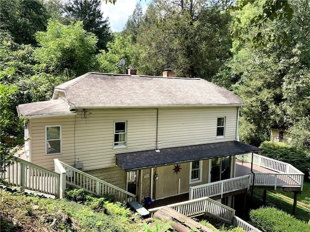 back of house featuring a wooden deck