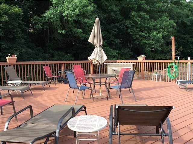 wooden deck featuring outdoor dining area