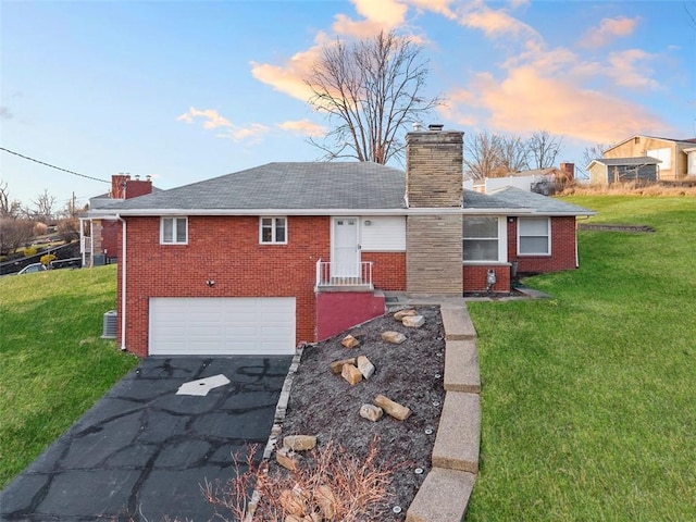 view of front of home featuring aphalt driveway, brick siding, a chimney, and a garage