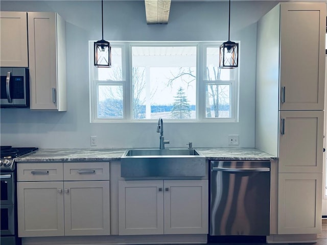 kitchen featuring a wealth of natural light, stainless steel appliances, and pendant lighting