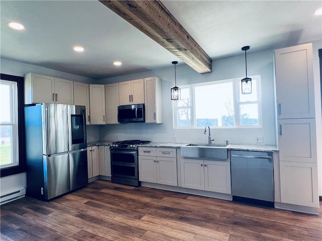 kitchen featuring dark wood-style floors, appliances with stainless steel finishes, a sink, decorative light fixtures, and beam ceiling