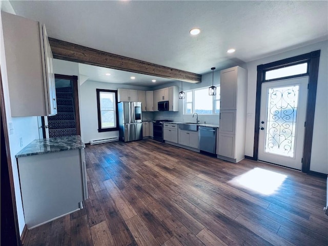 kitchen with a baseboard radiator, a sink, dark wood-style floors, decorative light fixtures, and appliances with stainless steel finishes