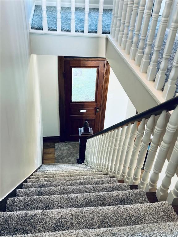 stairway with wood finished floors