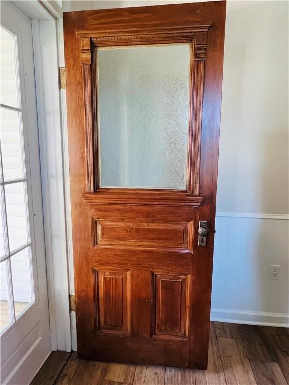 details with wainscoting and wood finished floors