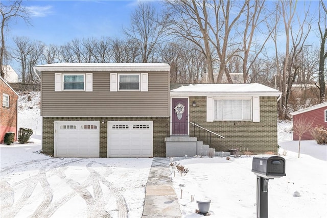 tri-level home featuring brick siding and an attached garage