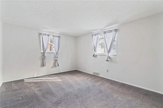 carpeted empty room with baseboards and visible vents