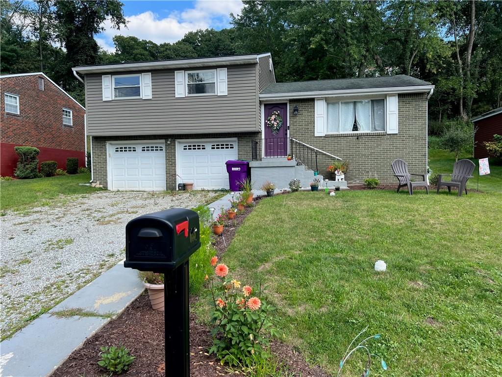 635 Harborview Dr, Plum Boro, PA 15239 - split level home featuring a front lawn, brick siding, and a garage