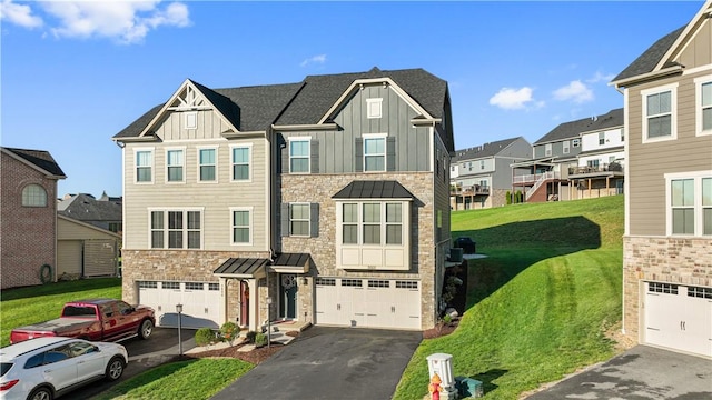 view of front of house with a standing seam roof, a residential view, board and batten siding, aphalt driveway, and a front yard