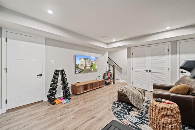 interior space featuring baseboards, recessed lighting, light wood-style flooring, and stairs