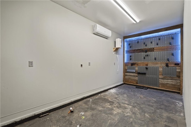 169 Clearview Rd, Raccoon Twp, PA 15001 - empty room featuring a wall mounted AC, unfinished concrete flooring, and a workshop area