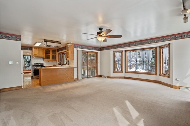 169 Clearview Rd, Raccoon Twp, PA 15001 - unfurnished living room with ceiling fan, light colored carpet, baseboards, and a sink