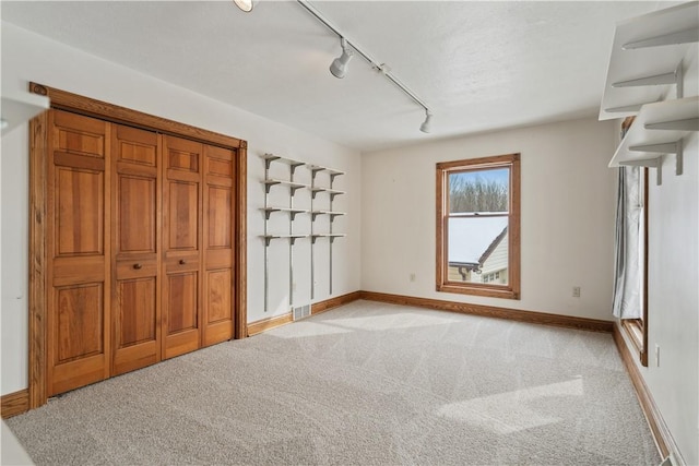 169 Clearview Rd, Raccoon Twp, PA 15001 - unfurnished bedroom with light colored carpet, baseboards, and track lighting