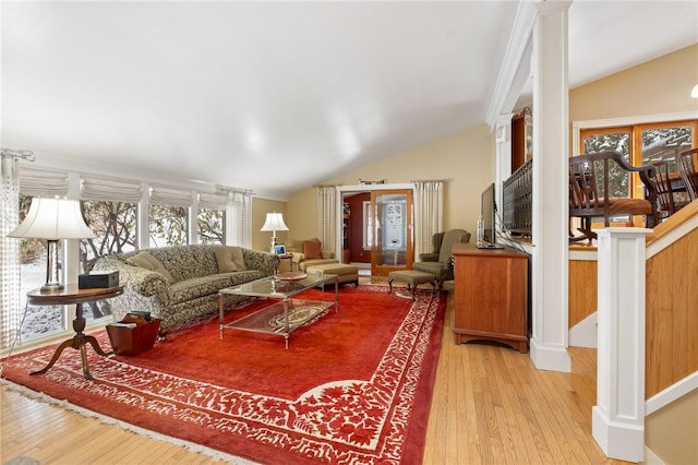 living area with light wood finished floors and lofted ceiling