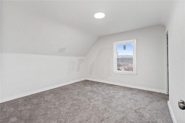 additional living space featuring lofted ceiling, carpet, and baseboards