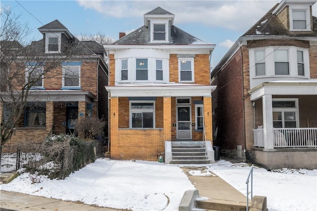 american foursquare style home with brick siding