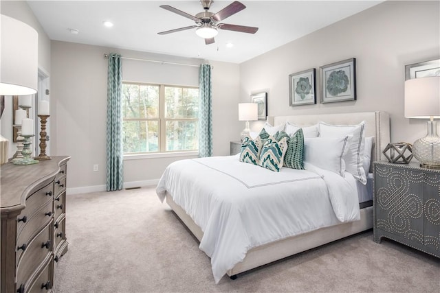 bedroom featuring light carpet, recessed lighting, a ceiling fan, and baseboards