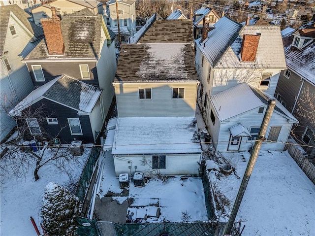 snowy aerial view with a residential view