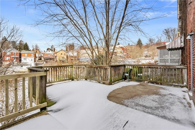 snowy yard featuring a residential view