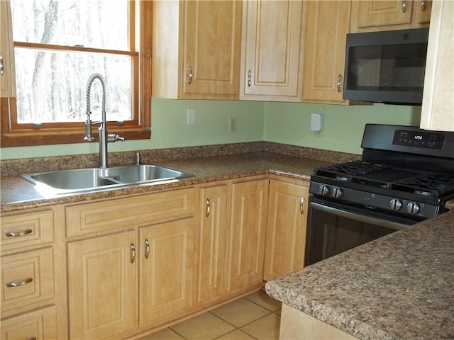 kitchen featuring dark countertops, light tile patterned flooring, a sink, and black range with gas stovetop