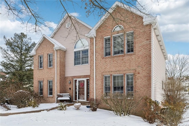 traditional-style home with brick siding