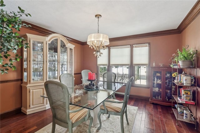 dining area featuring dark wood-style floors, baseboards, a chandelier, and crown molding