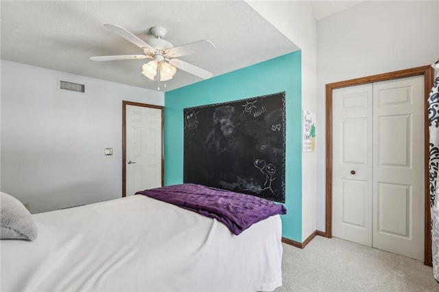 bedroom with light carpet, visible vents, baseboards, a ceiling fan, and a closet