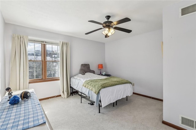 bedroom featuring baseboards, visible vents, and light colored carpet