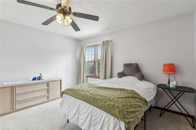 bedroom featuring light carpet and a ceiling fan