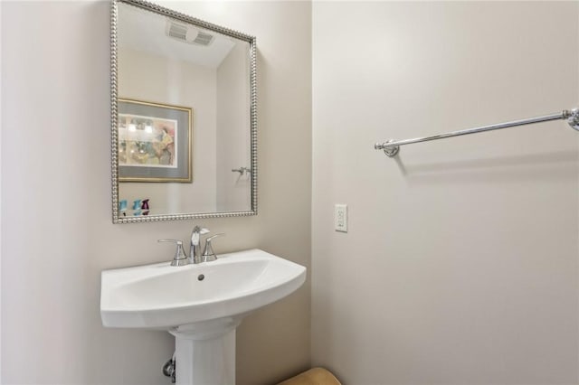 bathroom with visible vents and a sink