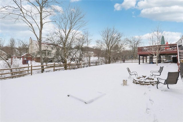 yard covered in snow with fence and a wooden deck