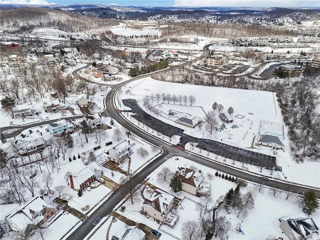 snowy aerial view with a residential view