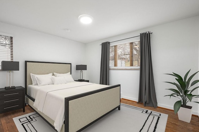 bedroom featuring dark wood-style flooring and baseboards