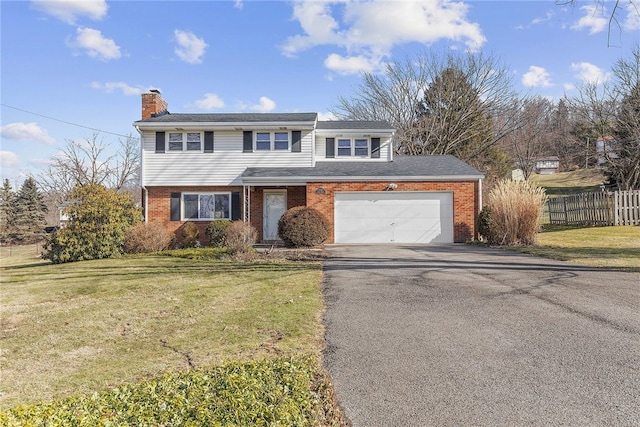 view of front of home featuring a chimney, aphalt driveway, fence, a front lawn, and brick siding