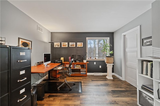 office with dark wood finished floors, visible vents, and baseboards