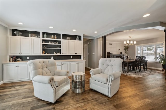 living area featuring baseboards, wood finished floors, and recessed lighting