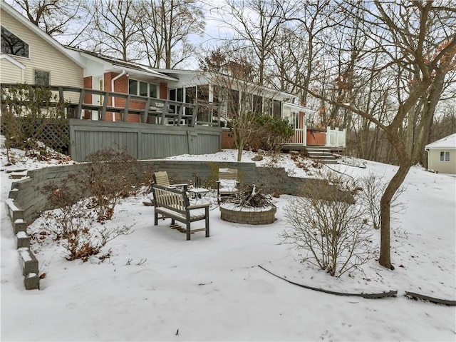 yard layered in snow with a deck