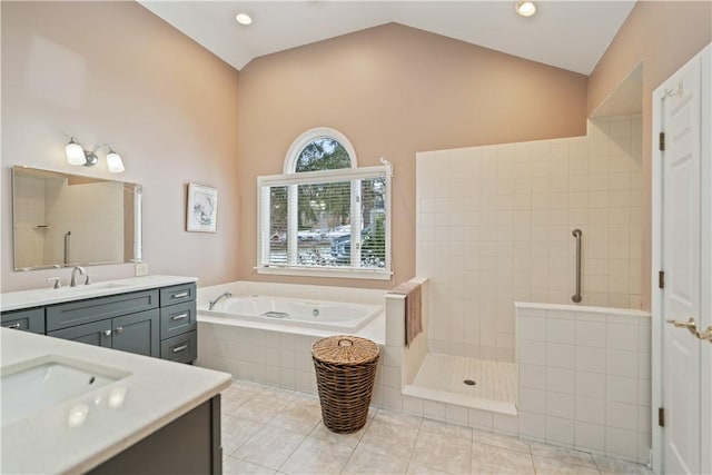 bathroom featuring lofted ceiling, a sink, tile patterned flooring, walk in shower, and two vanities