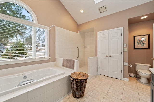 bathroom with a closet, toilet, vaulted ceiling, a walk in shower, and tile patterned floors